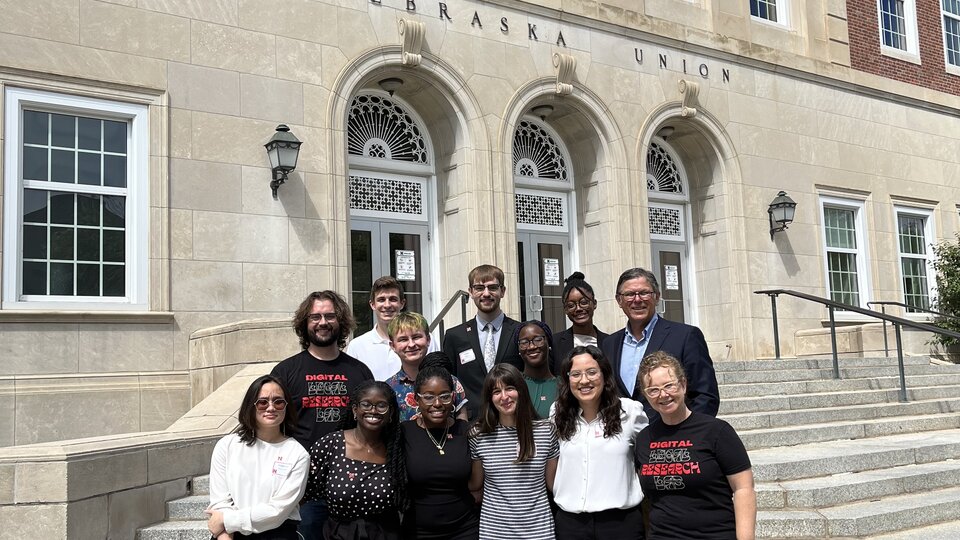 A group of students stand in front of the Nebraska Union.
